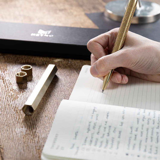 MetMo Brass pen in use writing in a book